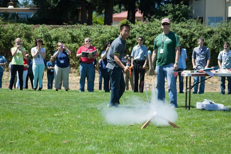 WAS participants watch a student-made rocket blast off.