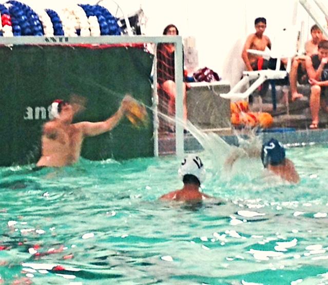 GHHS Boys Water Polo Member shoots a goal.