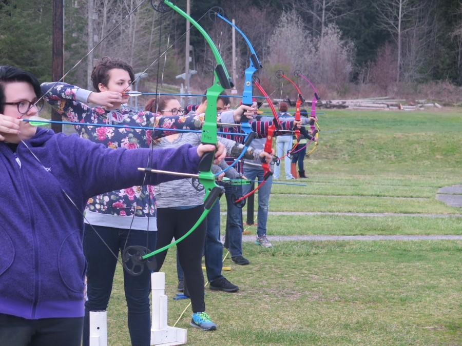 Members of the Archer Club line up and shoot simultaneously.