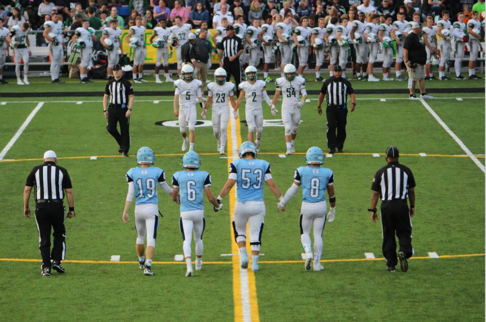 The Tides and the Seahawks approach each other for a handshake before the big game. Impage captured by yearbook staff.