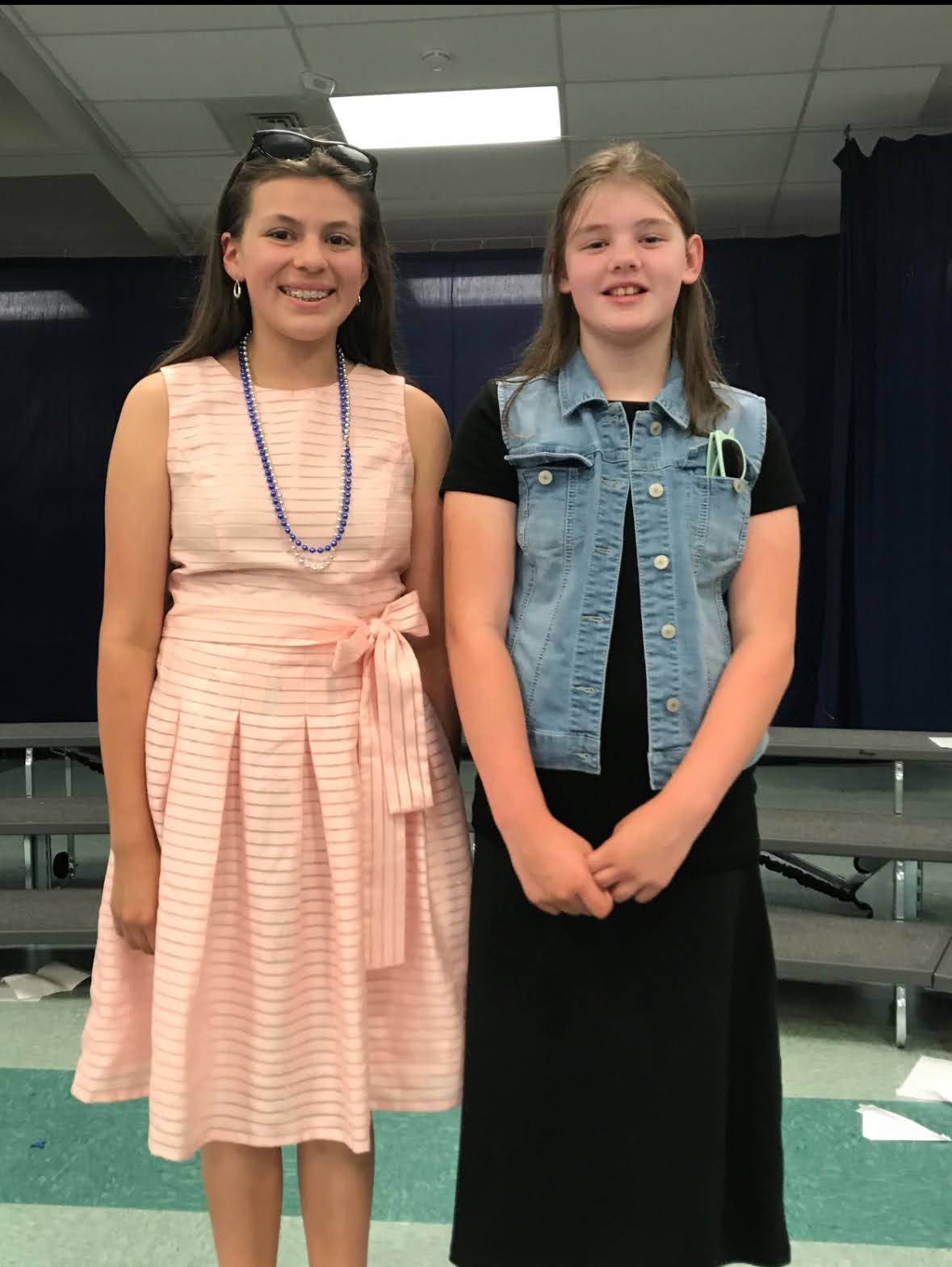 Current seniors Cassandra Garay (12) and Kylie Klipper (12) stand side by side as young children